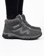 Women’s dark gray fur-lined snow boots with hook-and-loop straps and lug tread sole
