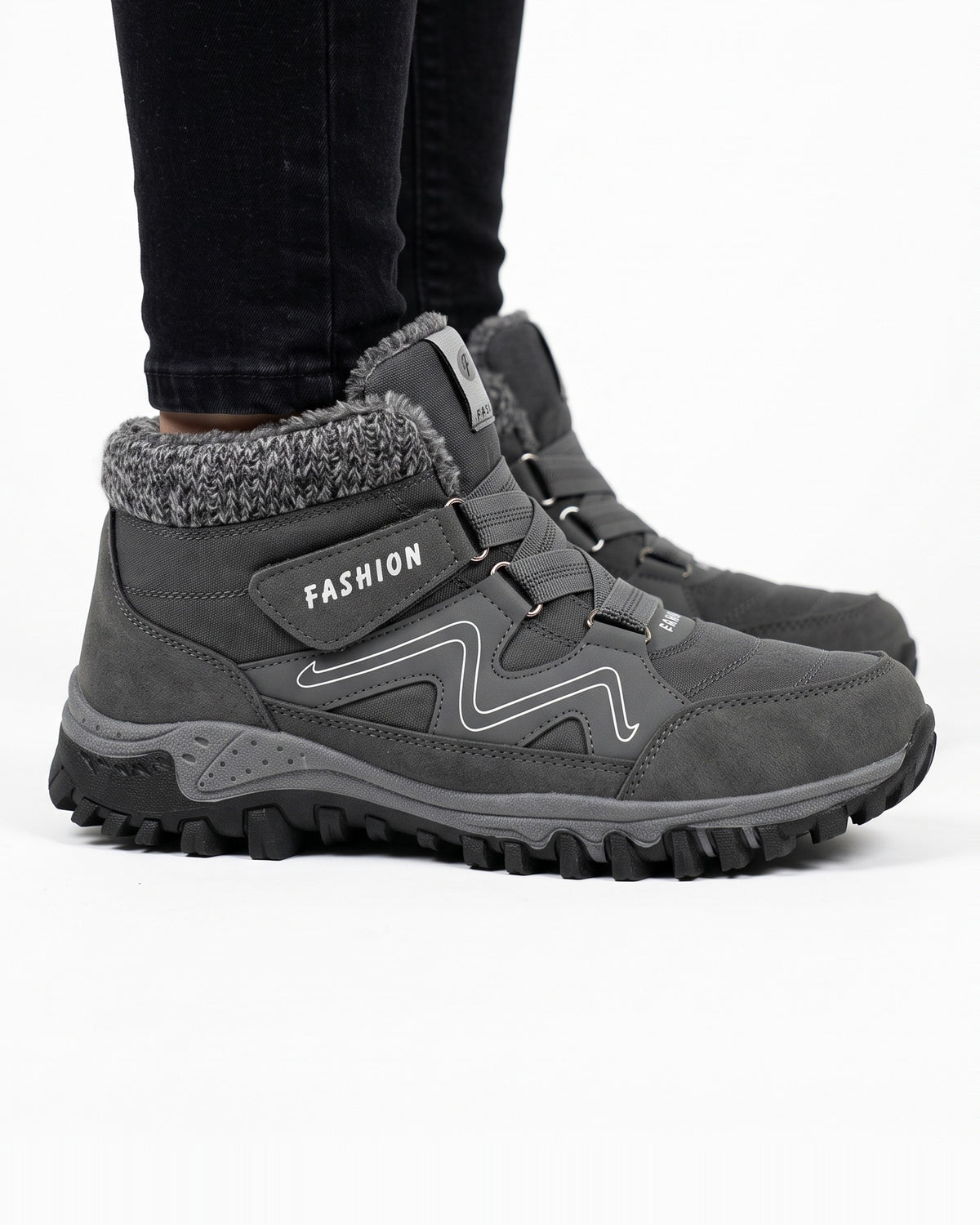 Women’s dark gray fur-lined snow boots with hook-and-loop straps and lug tread sole