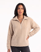 Beige fuzzy half-zip pullover with spread collar, ribbed plush fleece; worn with dark pants