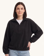 Black half-zip fleece pullover with oversized stand collar and long sleeves