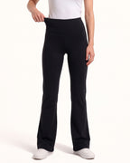 Black high-waisted flare yoga leggings, back view with straight-to-bootcut legs.