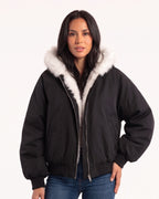 Black padded bomber jacket with white faux fur hood lining, zip front and ribbed cuffs