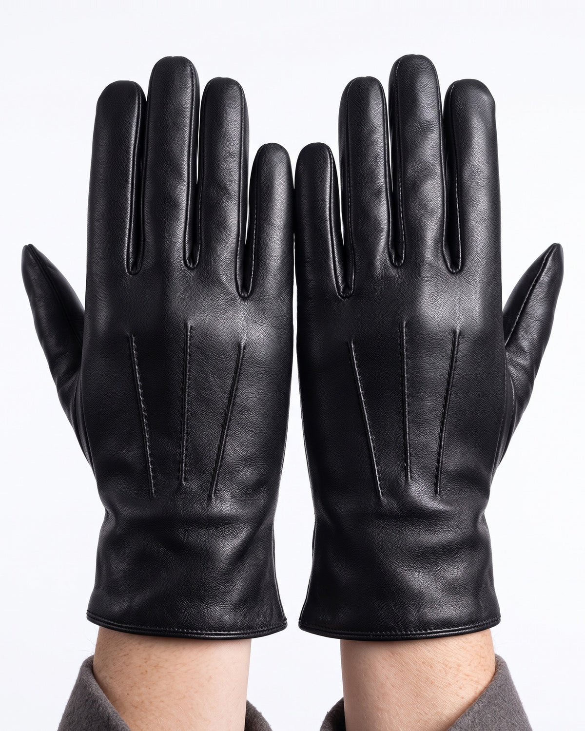 Black leather gloves with stitched finger panels, fleece-lined winter style.