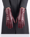 Women’s burgundy leather winter gloves, fleece-lined cuffs and five-finger design