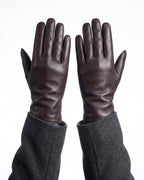 Dark brown leather winter gloves with gray fleece lining and long stitched cuffs
