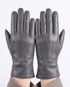 Dark gray leather gloves with stitched finger panels, fleece-lined winter style.