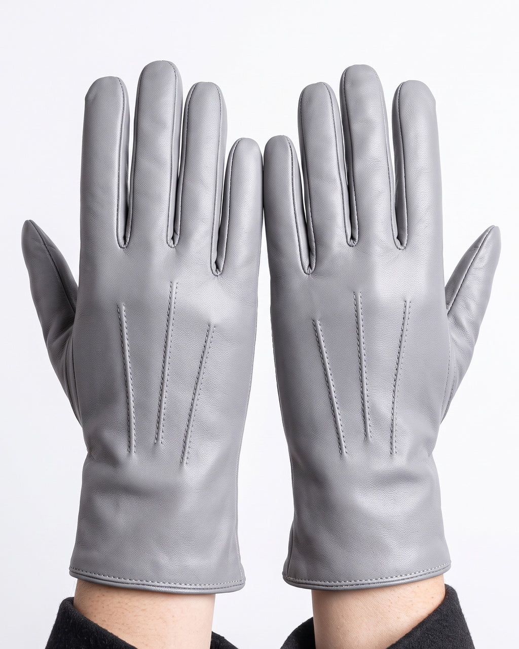 Light gray leather winter gloves with dark gray fleece lining and stitched panels
