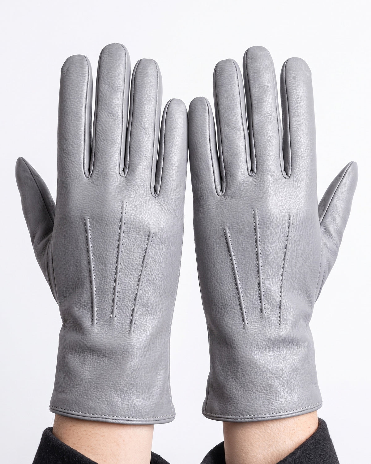 Light gray leather winter gloves with dark gray fleece lining and stitched panels