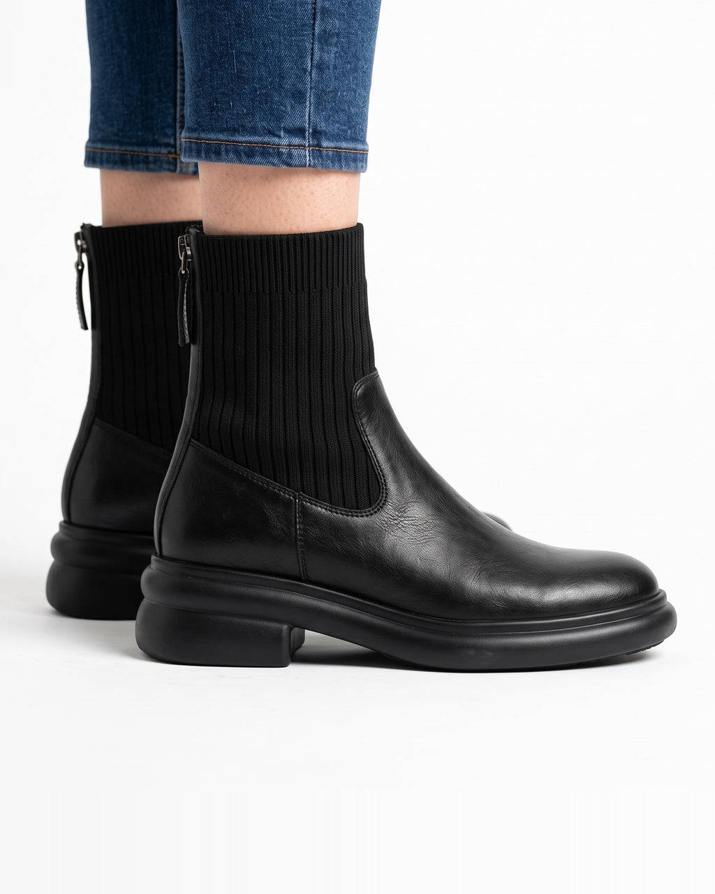 Black leather sock ankle boots with ribbed knit shaft, back zip, chunky platform sole