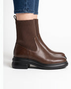 Brown leather sock ankle boots with ribbed knit shaft, back zip, chunky platform sole