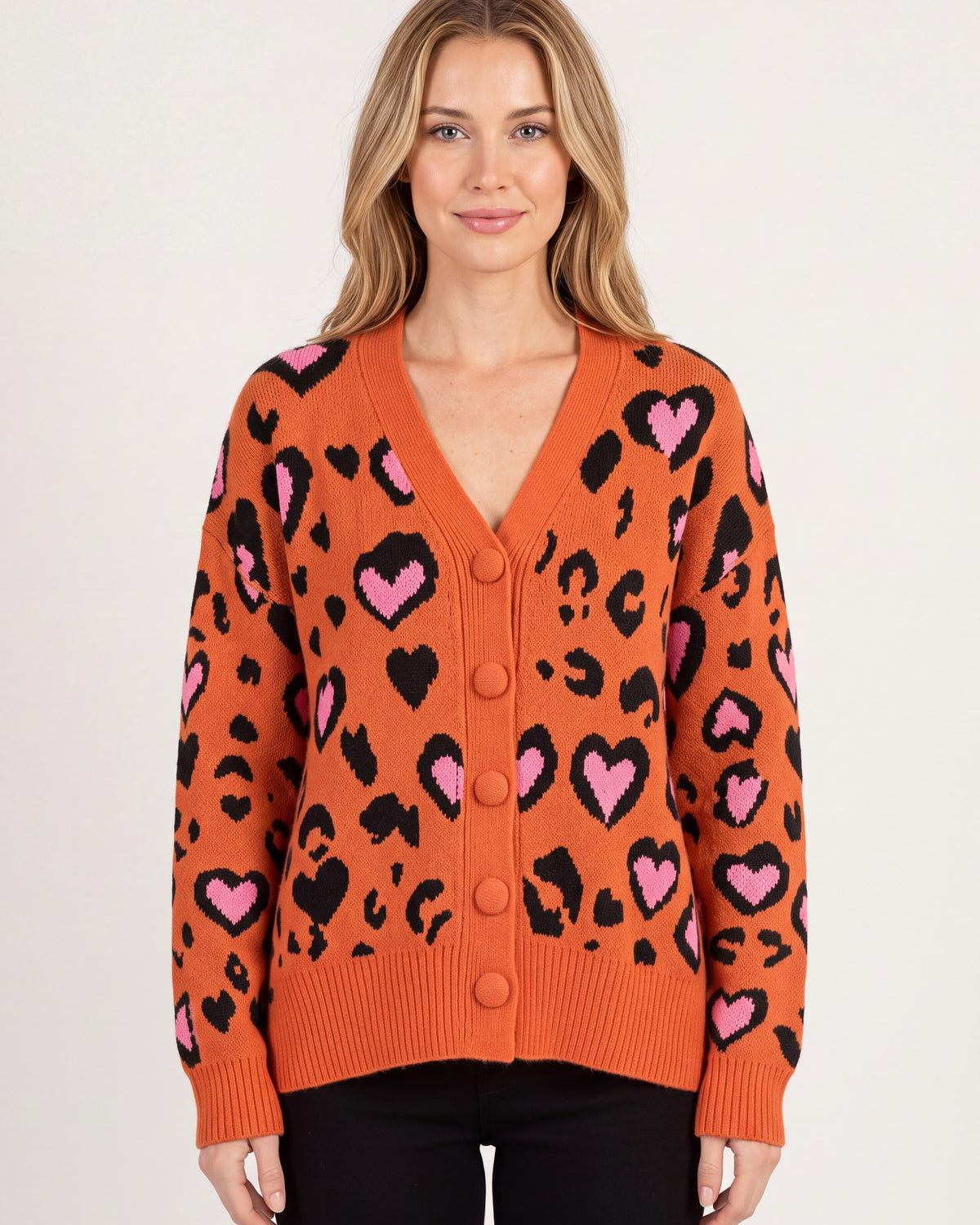 Leopard Print Cardigan for Women — Oversized V Neck Button Front Knit with Heart Motif in Orange — studio model photo [ai-studio]