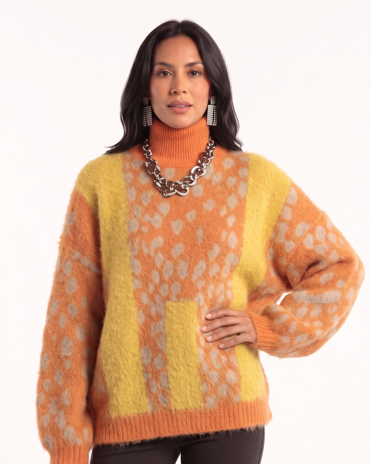 Orange and yellow spotted pullover with an orange turtleneck, ribbed trim, and oversized sleeves
