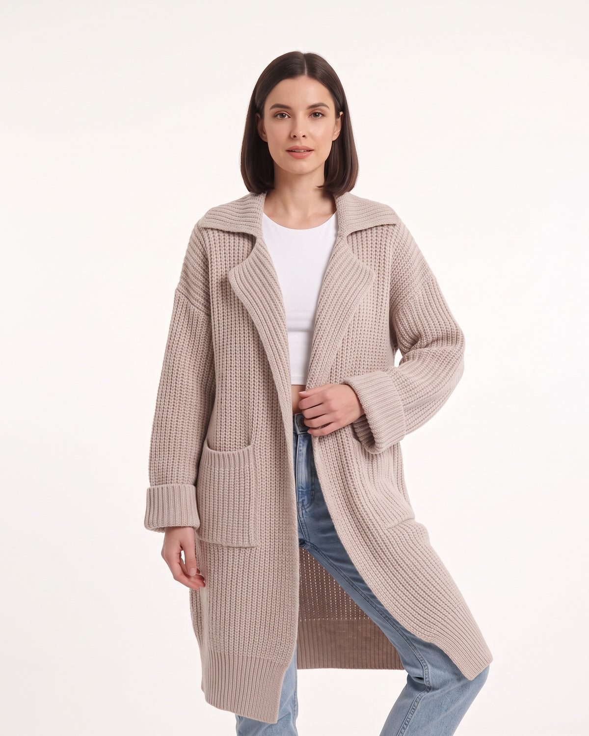 Beige long duster cardigan with chunky knit texture, notched collar, and patch pockets