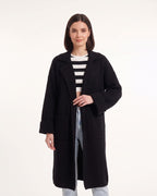 Black long duster cardigan with chunky knit texture, notched collar and side pockets