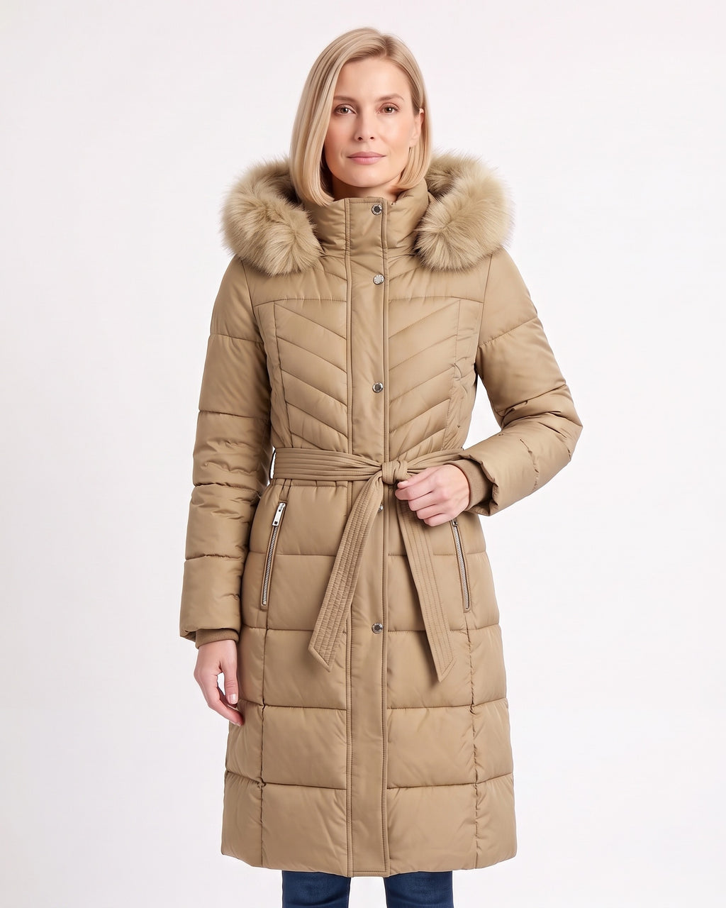 Women's long beige puffer coat with faux fur trimmed hood, belt, and chevron quilting
