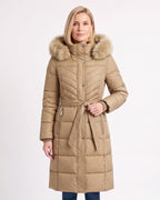 Women's long beige puffer coat with faux fur trimmed hood, belt, and chevron quilting