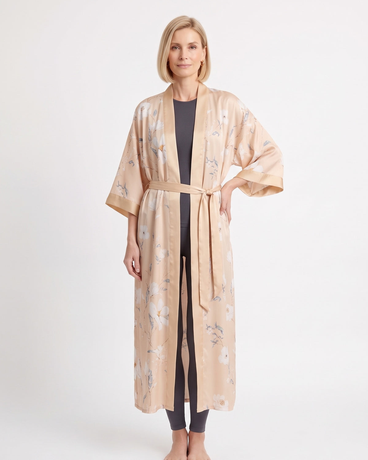 Light beige satin kimono robe with small animal-and-floral print, wide sleeves, tie belt.
