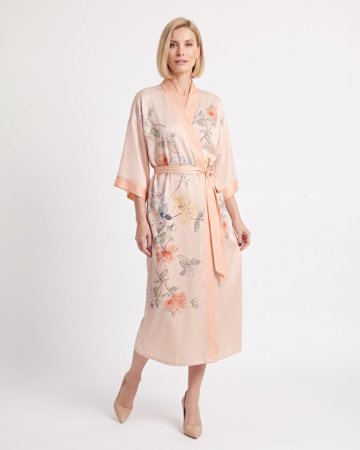 Peach satin kimono robe with delicate floral illustrations, V-neck, wide sleeves, tie belt.