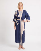Navy satin kimono robe with white floral embroidery, V-neck, wide sleeves, cream tie belt.