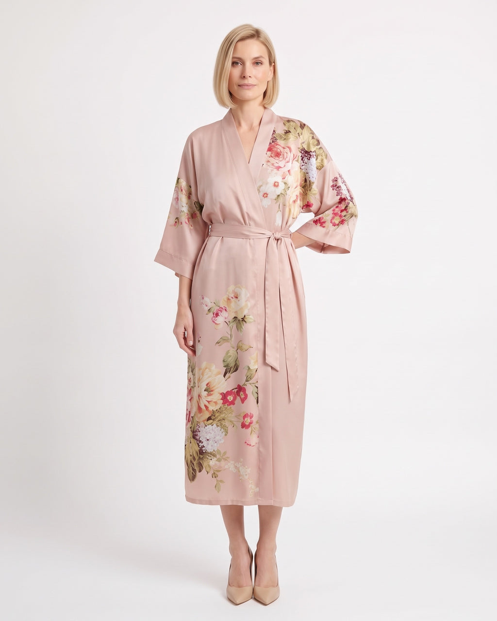 Blush satin kimono robe with floral print, V-neck, wide sleeves, and tie belt.