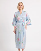 Light blue satin wrap kimono robe with pastel floral print, wide sleeves, and tie belt