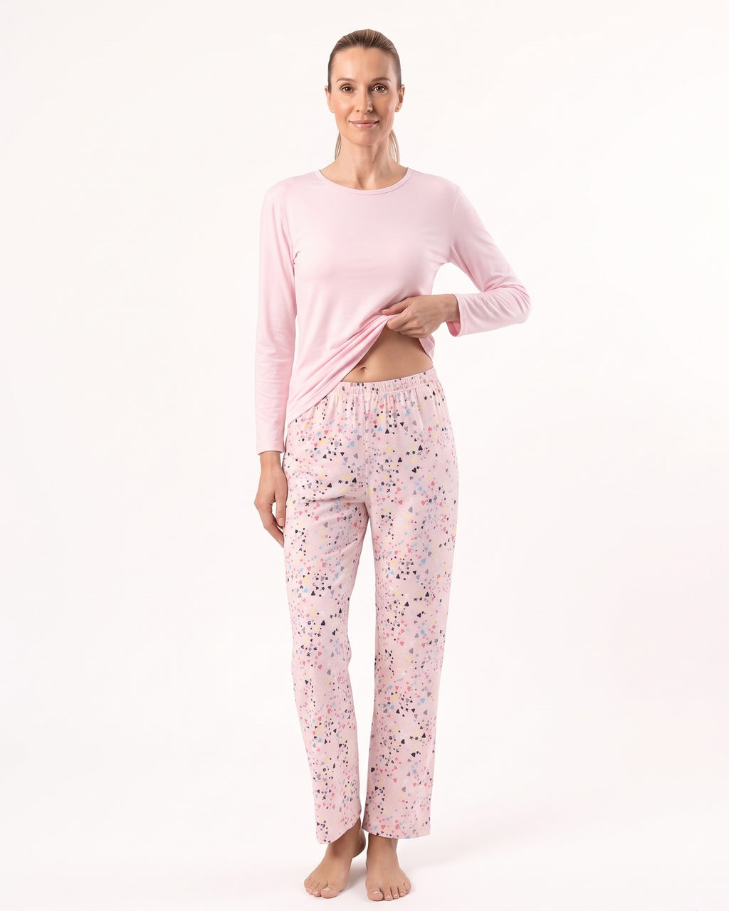 Women’s long-sleeve crew neck pajama set, light pink top with printed pajama pants.