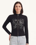 Black long-sleeve zip-up top with stand collar and distressed graphic front