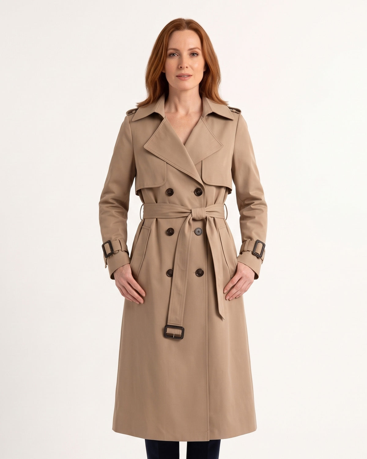 Khaki women’s trench coat with belt, double-breasted buttons, and buckle straps at cuffs