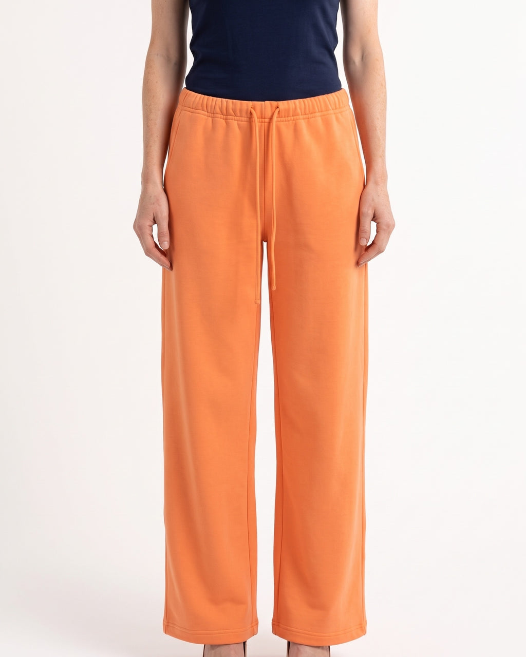 Orange low-rise wide-leg sweatpants with drawstring waist and side pockets