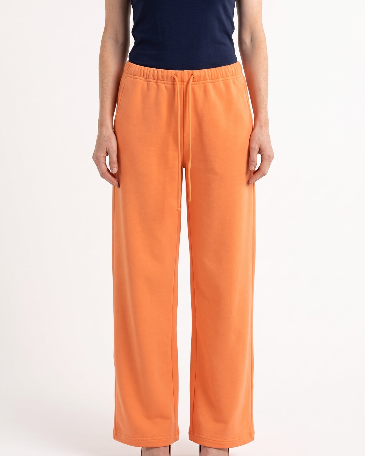 Orange low-rise wide-leg sweatpants with drawstring waist and side pockets