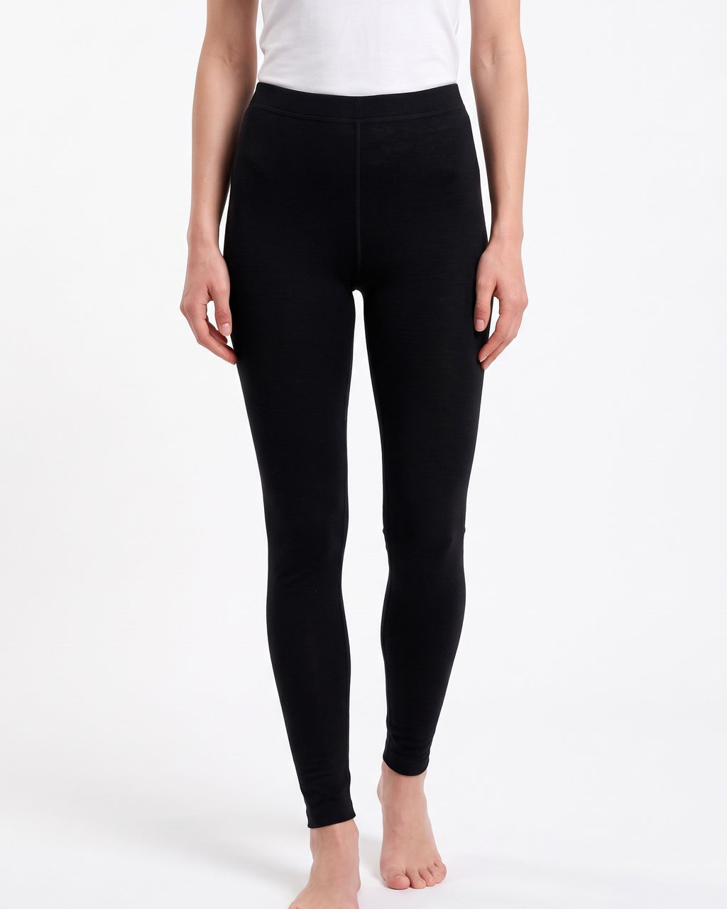 Women's black merino wool thermal leggings, full-length with smooth waistband.