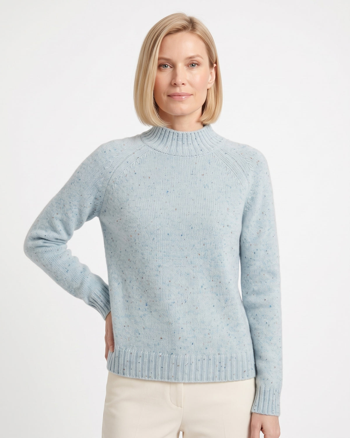 Women’s light blue speckled mock neck sweater with ribbed hem and long raglan sleeves