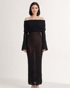 Off-shoulder long-sleeve knit maxi dress in black, column silhouette with wide neckline.