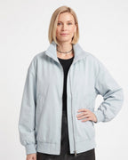 Light blue oversized cotton twill bomber jacket with stand collar zip front and side pockets