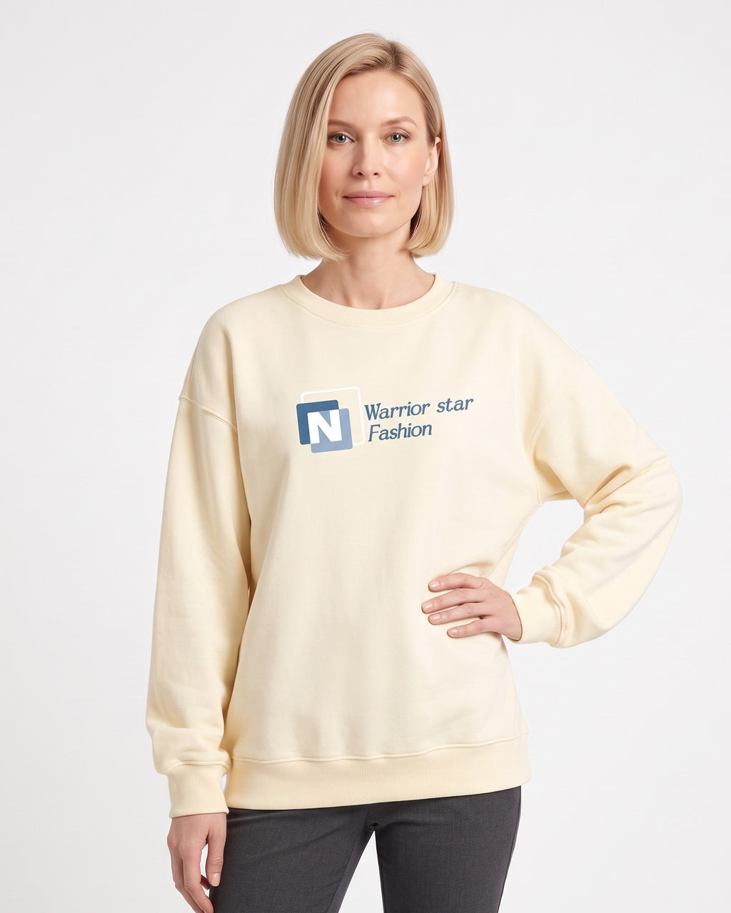 Cream crewneck sweatshirt with N logo graphic, long sleeves, ribbed cuffs.