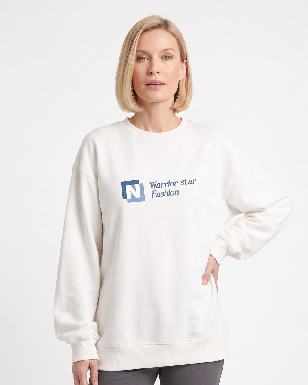 White crewneck sweatshirt with N logo graphic, long sleeves, ribbed hem.