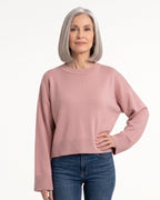 Blush pink oversized cropped crew-neck knit sweater with ribbed hem and wide sleeves