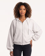 White oversized cropped zip-up hoodie with hood and balloon sleeves, zip front