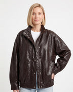 Oversized dark brown faux leather jacket, snap front with stand collar, ribbed cuffs