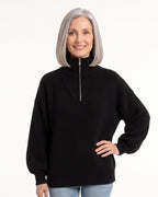 Black ribbed half-zip sweater with funnel neck, drop shoulders, long sleeves