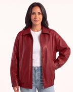 Red oversized faux leather bomber jacket with collar, zip front, drop shoulders and snap cuffs