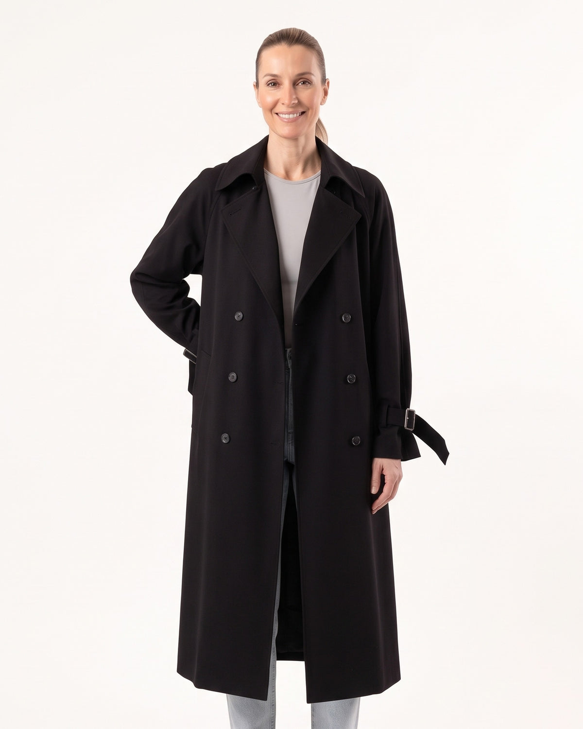 Black long double-breasted trench coat with wide lapels and cuff details