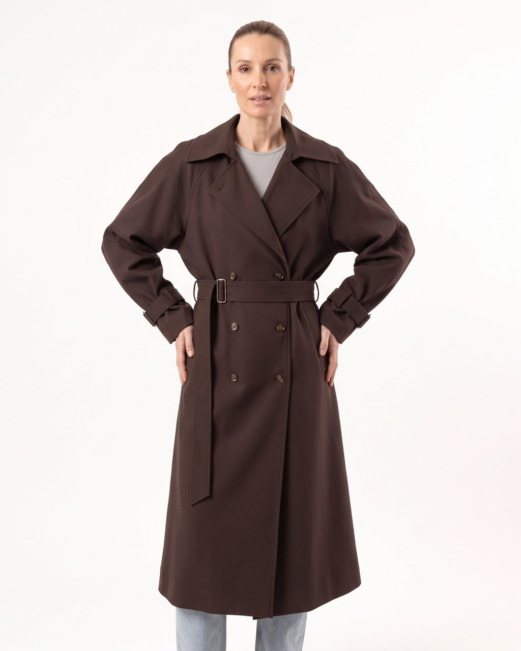 Brown long double-breasted trench coat with waist belt and buckled cuff straps