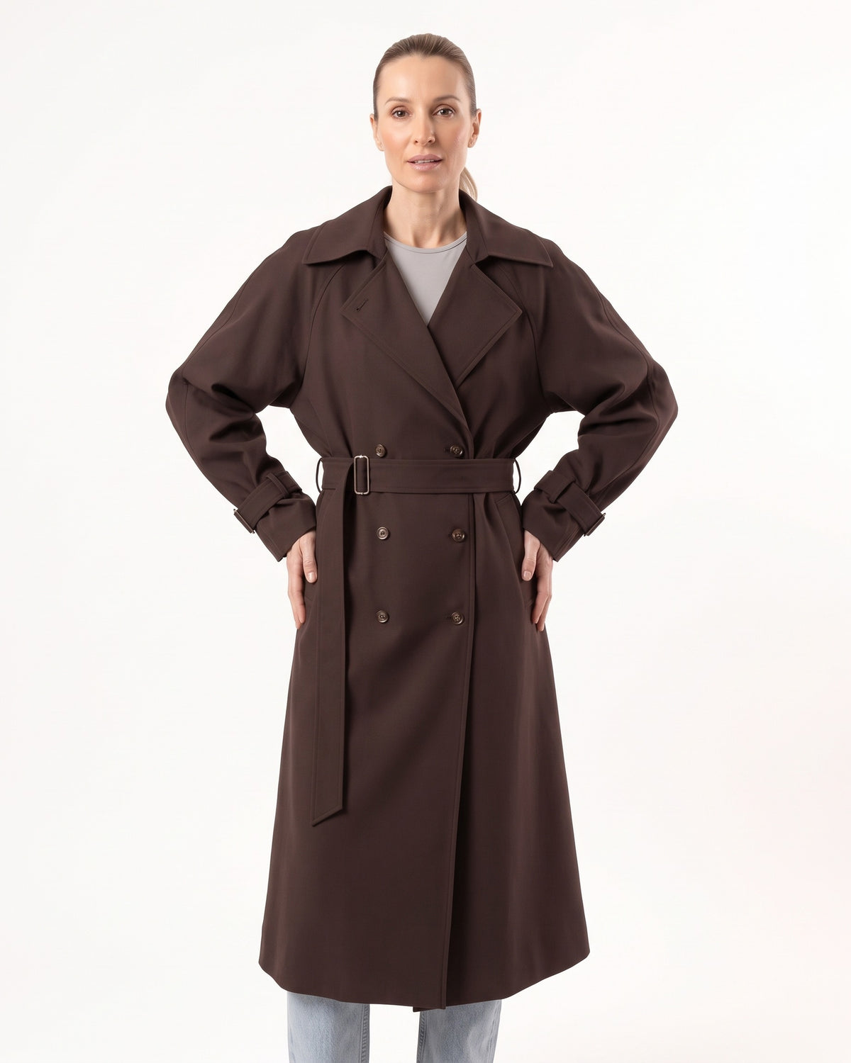 Brown long double-breasted trench coat with waist belt and buckled cuff straps