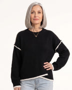 Black oversized crew neck knit pullover with contrast trim and relaxed drop-shoulder sleeves