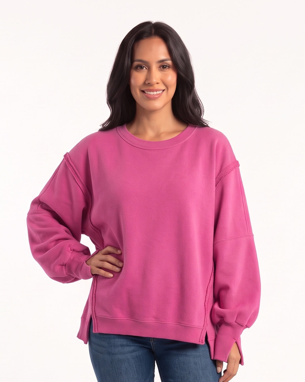 Women's oversized hot pink sweatshirt with batwing sleeves, exposed seams, and side slits