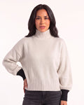 White oversized turtleneck knit sweater with balloon sleeves and ribbed cuffs and hem