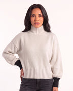 White oversized turtleneck knit sweater with balloon sleeves and ribbed cuffs and hem