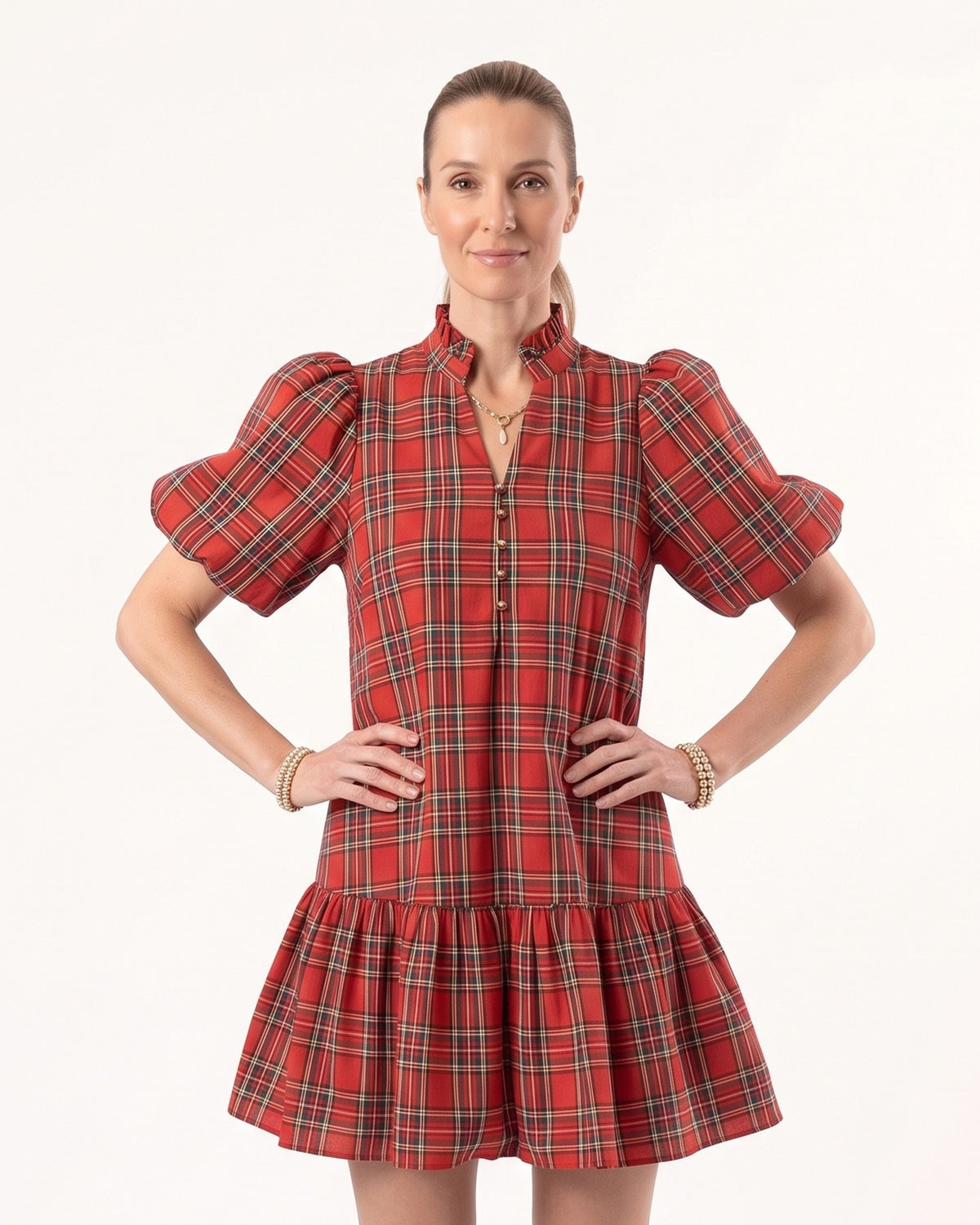 Plaid mini dress with puff sleeves and tiered skirt, red base with green and navy plaid
