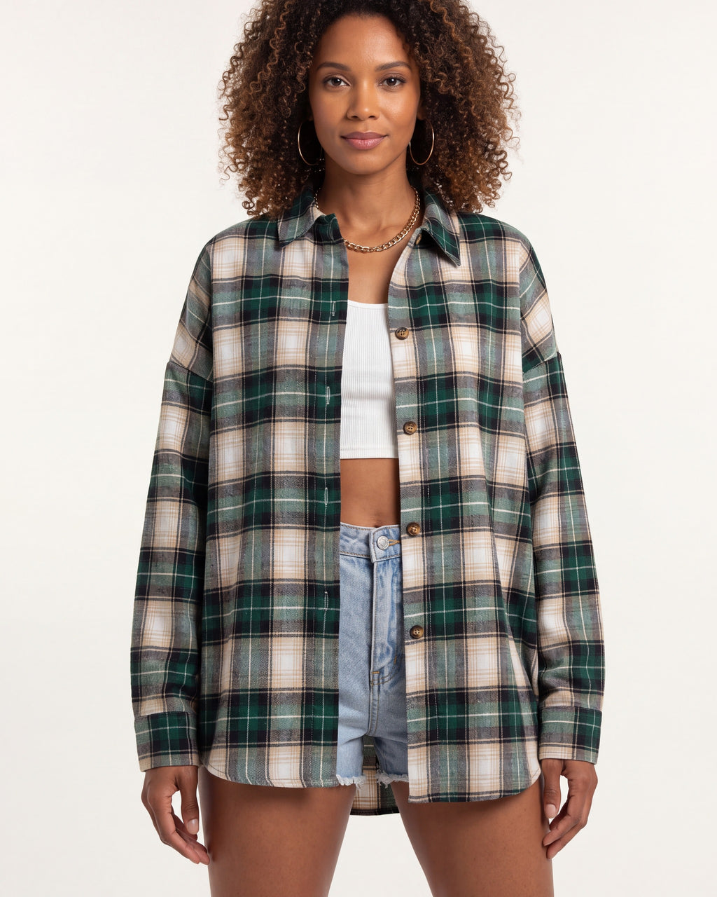 Oversized women's plaid button-down shirt in green, tan and white, long sleeves, buttons